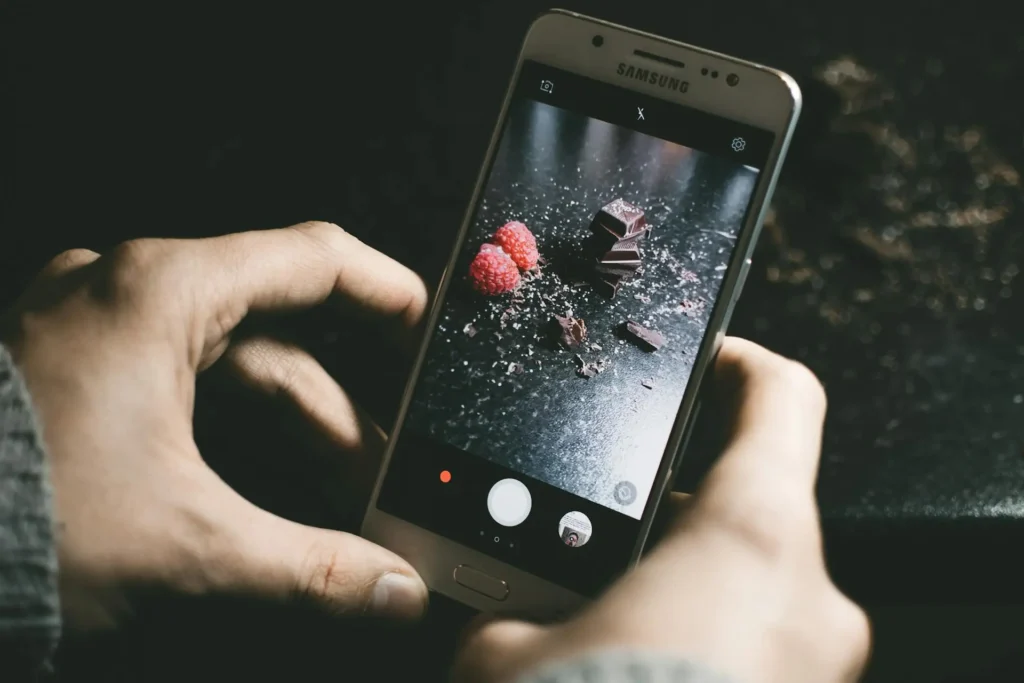 A photographer's hand adjusting settings on a camera, illustrating composition rules for stunning shots.