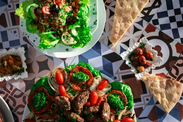 A traditional dinner setting with a variety of cultural dishes from different regions displayed on a table.