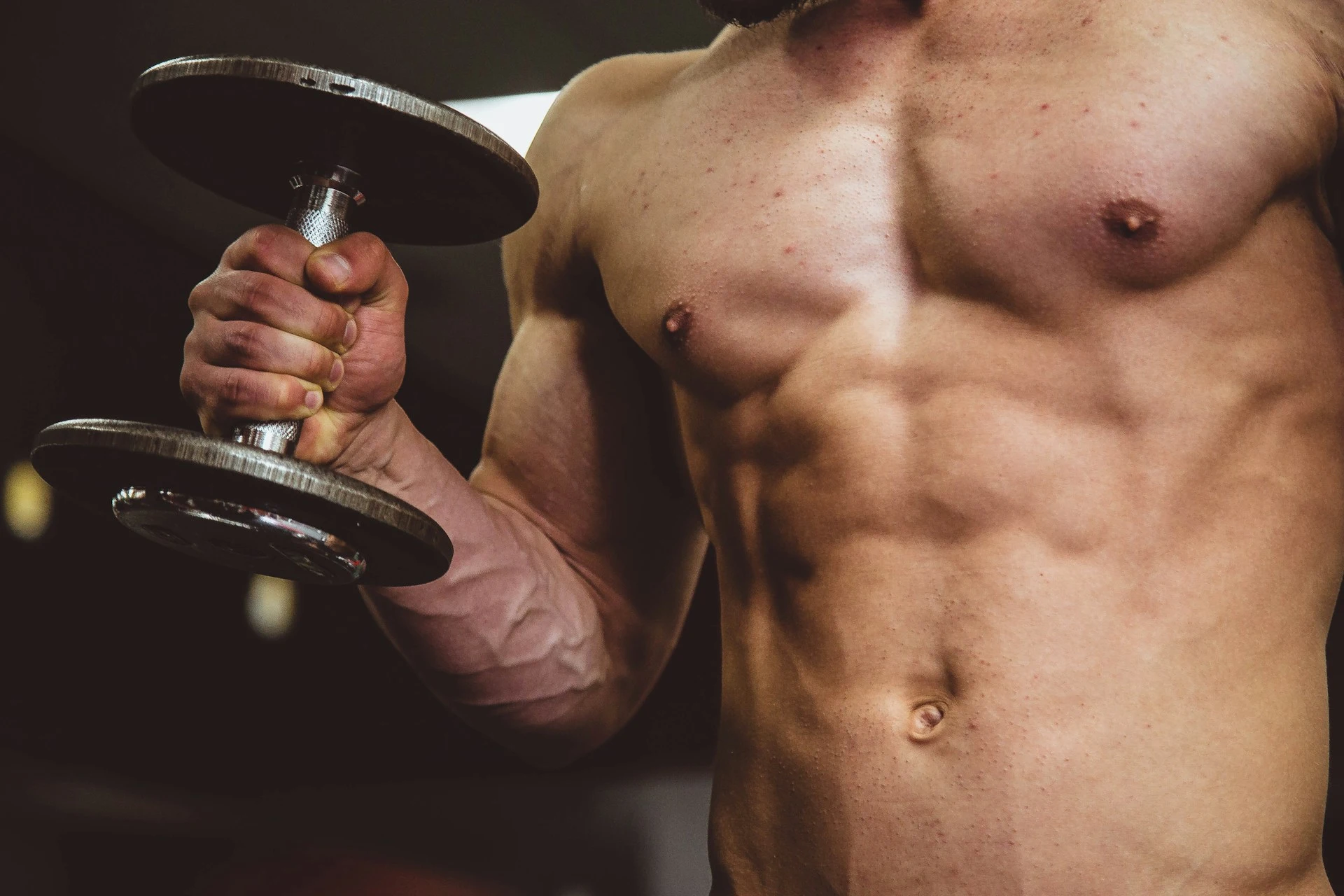 A variety of protein-rich foods including chicken breast, eggs, and protein powder on a kitchen countertop.