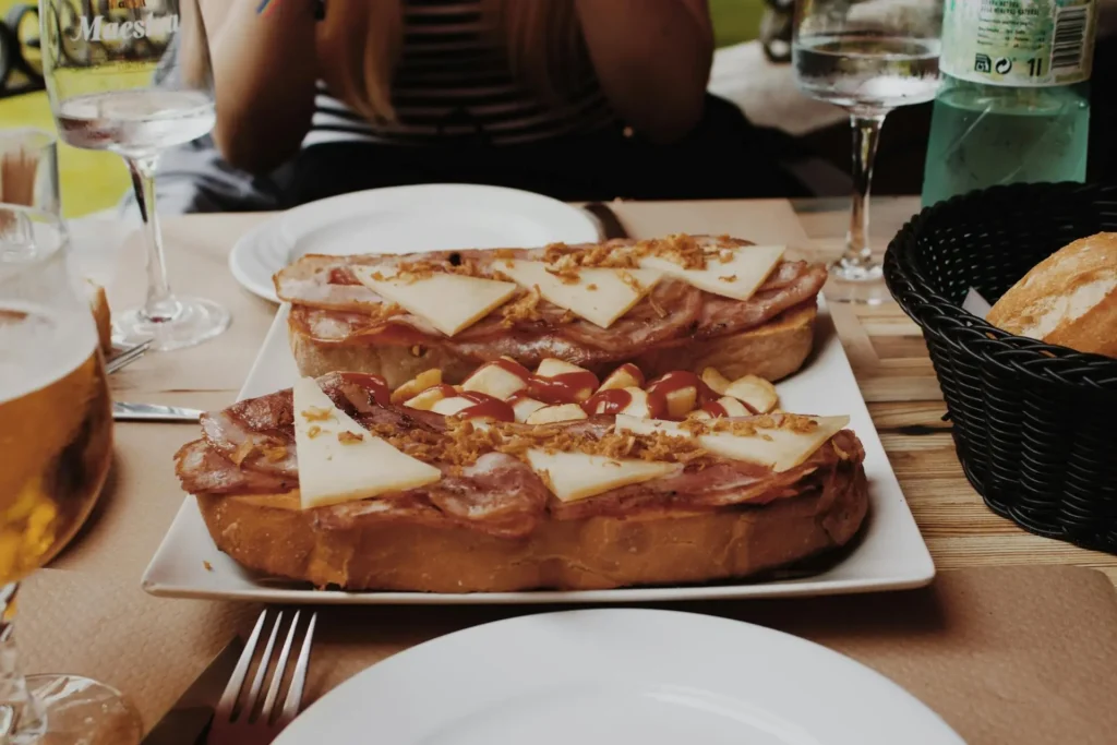 A table filled with a variety of traditional Spanish dishes, including paella, tapas, and jamón serrano.