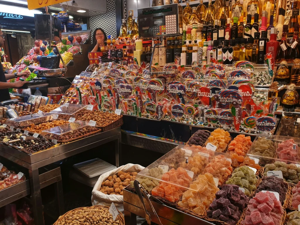 A selection of traditional Spanish street food, including churros, empanadas, and pintxos, displayed at a market stall.