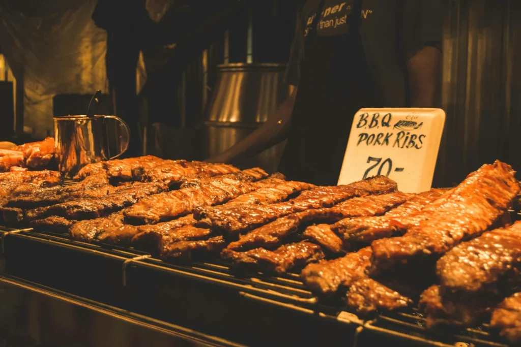 A busy street in Thailand with vibrant food stalls serving a variety of traditional Thai street food.