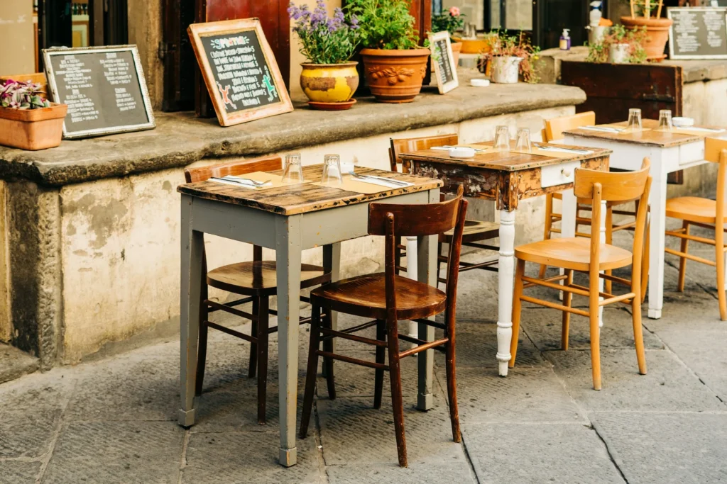 A rustic Tuscan table set with a variety of traditional dishes, including bruschetta, pasta, and a bottle of red wine.