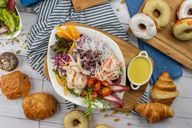 A selection of iconic dishes from around the world, including sushi, tacos, and spaghetti, displayed on a table.