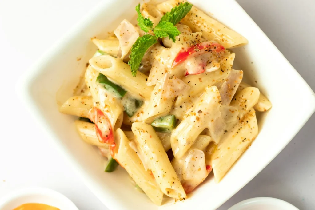 A plate of freshly made Italian pasta with tomato sauce and basil, served at a rustic Italian restaurant.