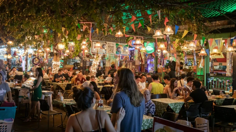 A bustling street food market with a variety of food stalls offering diverse dishes and snacks.