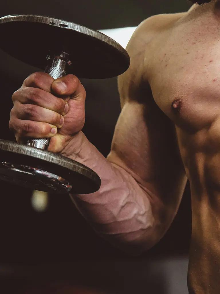 A variety of protein-rich foods including chicken breast, eggs, and protein powder on a kitchen countertop.